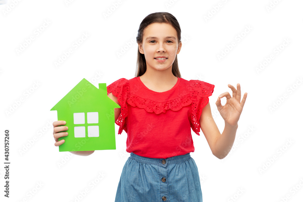 eco living, environment and sustainability concept - smiling little girl holding green house icon and showing ok hand sign over white background eco living, environment and sustainability concept - smiling little girl holding green house icon and showing ok hand sign over white background