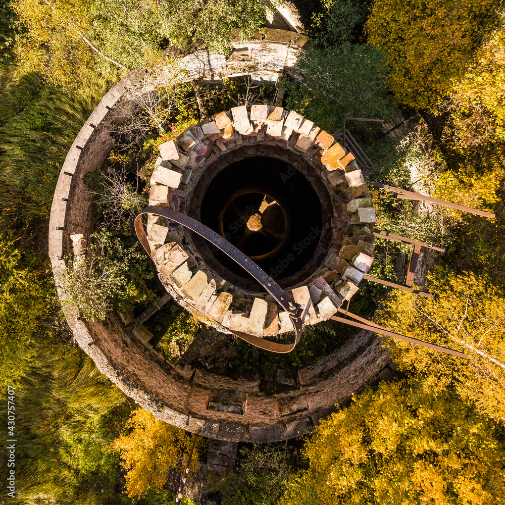 Abandoned lime kiln tower in sunny autumn day, Latvia.