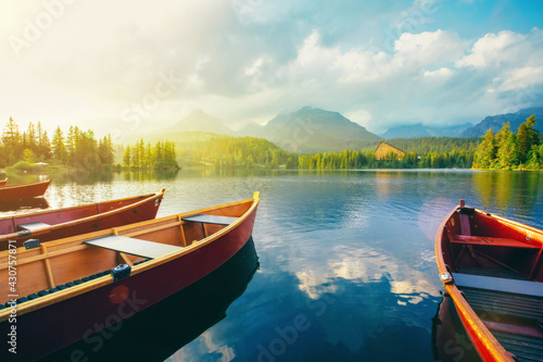 Boats on calm mountain lake Strbske pleso in Slovakia.