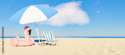 umbrella with flamingo float and chair on the sandy beach