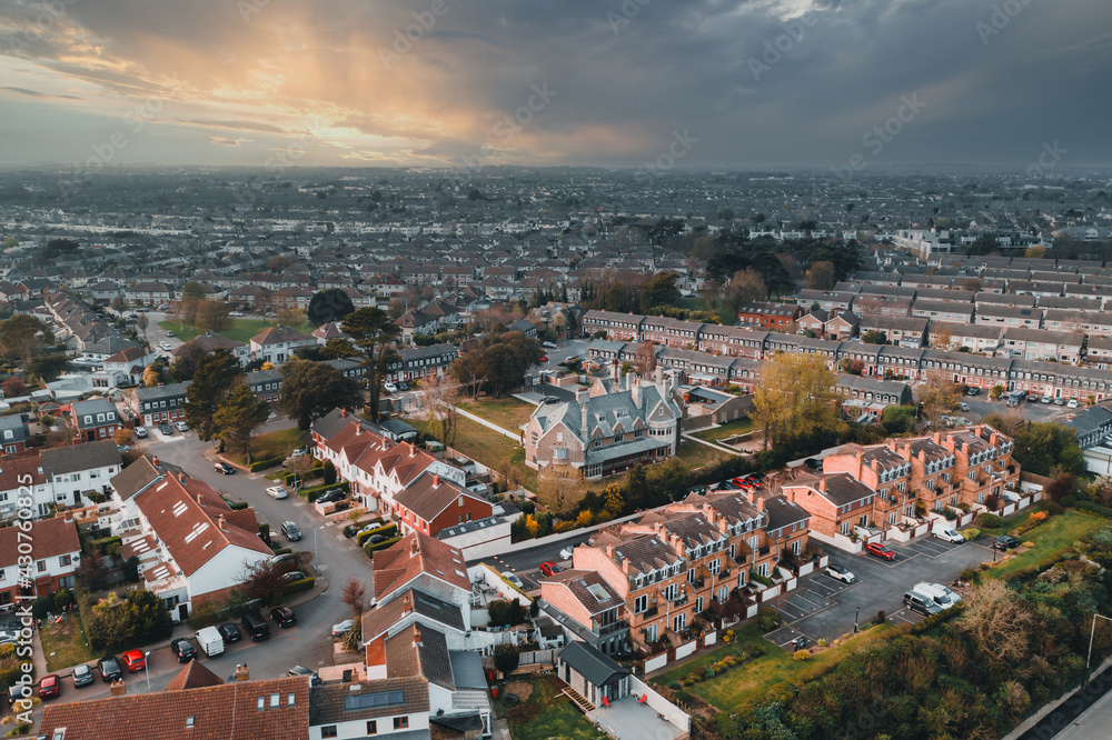 Aerial view over the Raheny and James Larkin Rd, Donaghmede, area on the Northside of Dublin. Irish cityscape at sunset viewed from Bull Island.