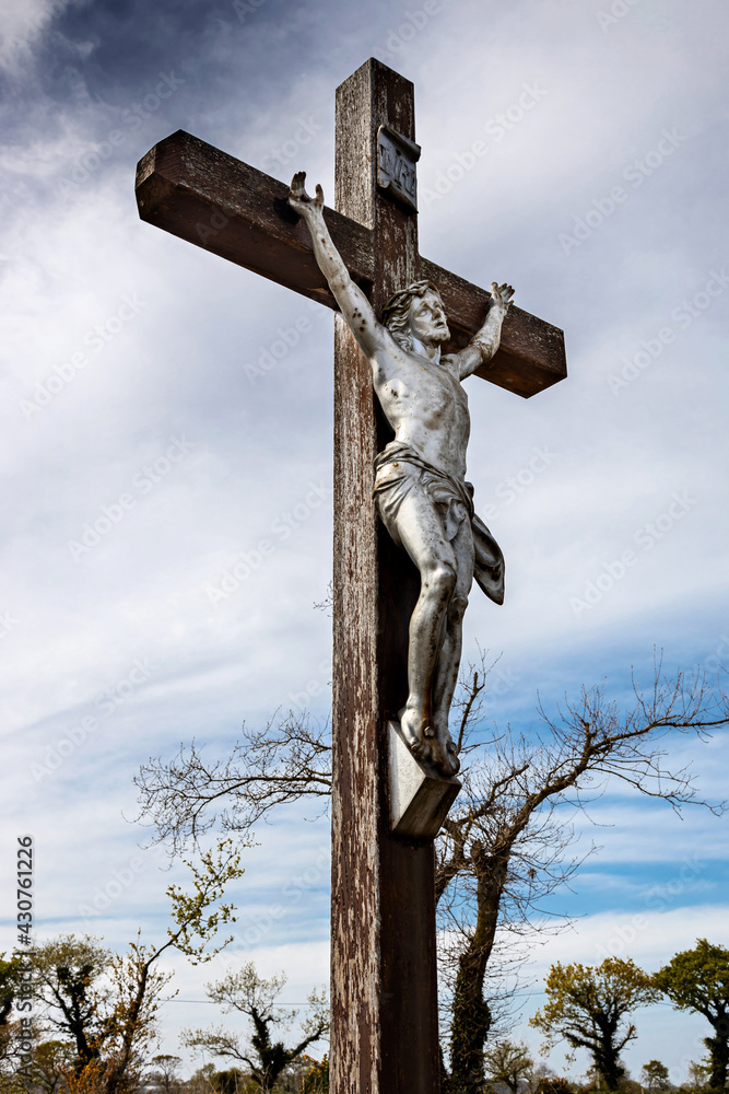 Christ on the cross, calvary in the Breton countryside Christ on the cross, calvary in the Breton countryside
