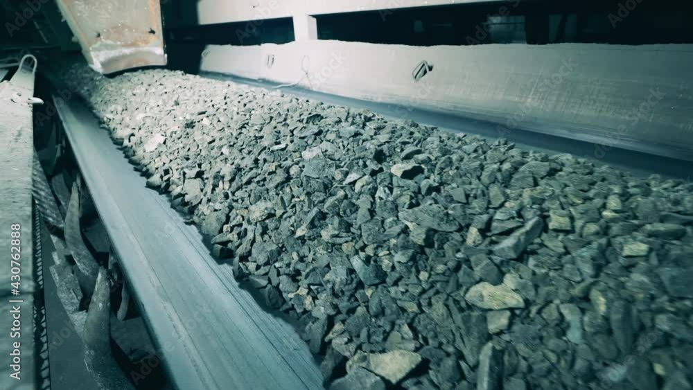 Transporting mechanism with crumbled ore on it. Mining industry, fossil, minerals processing. Transporting mechanism with crumbled ore on it. Mining industry, fossil, minerals processing.