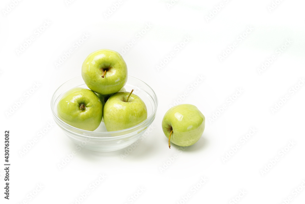 green apples in a transparent plate on a white background. Healthy eating green apples in a transparent plate on a white background. Healthy eating