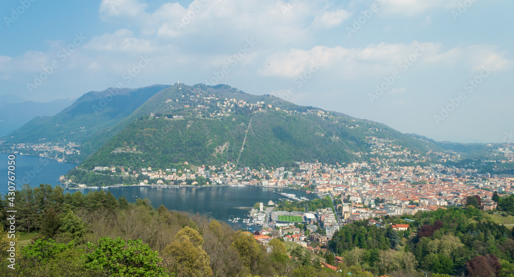 Panoramic aerial view of the city of Como facing the famous Lake Como and the surrounding mountains