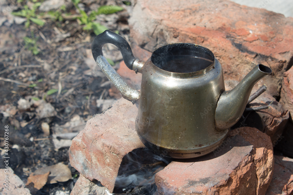We cook ground coffee beans on a fire, in nature. We cook ground coffee beans on a fire, in nature.