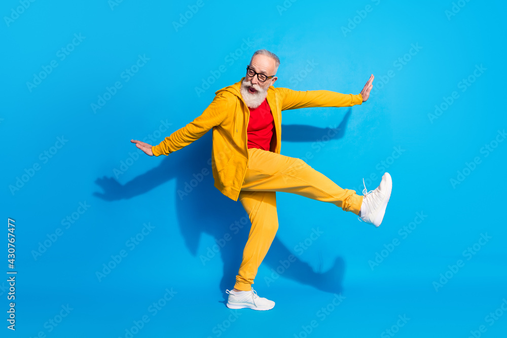 Full size photo of crazy excited positive funky mature man grandfather dancing fooling isolated on blue color background