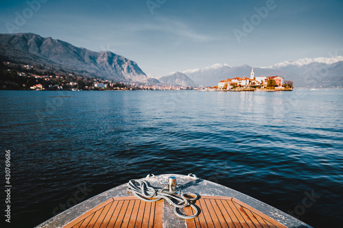 Closeup on a bow of tourist boat while surfing Lake Maggiore with the Borromee Islands in the background