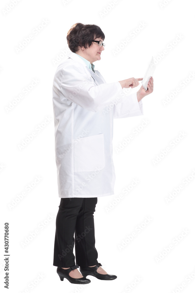 in full growth. senior female doctor with a digital tablet . in full growth. senior female doctor with a digital tablet .