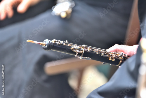 Photos oboe in the hands of a musician, during a classical music concert