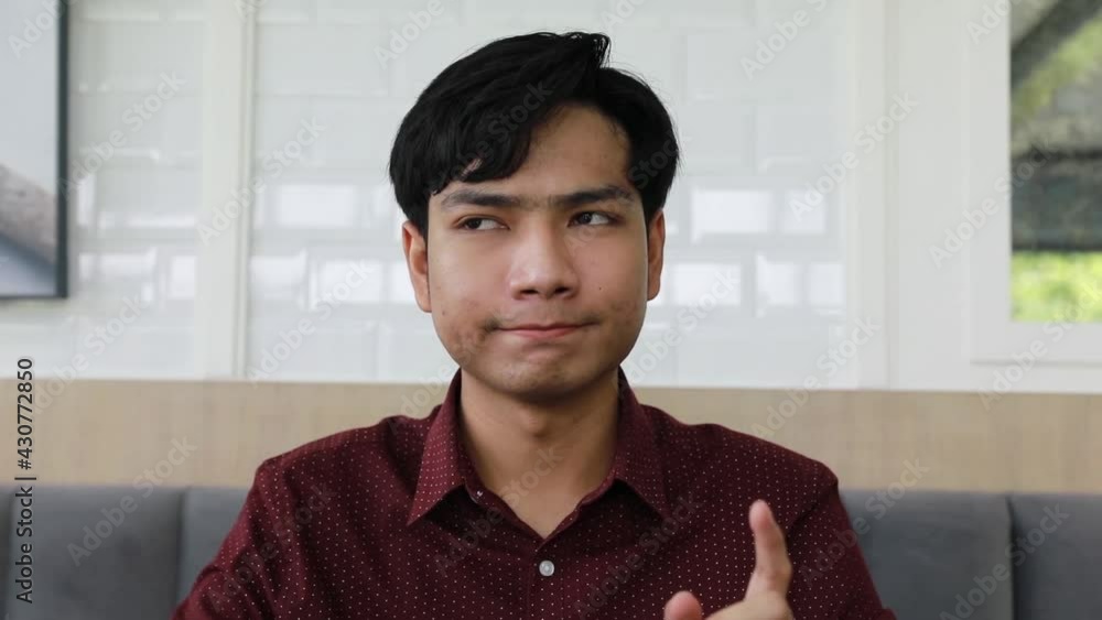 Asian Businessman confident man looking at the camera, holding a conversation with business client online. Pleasant smart male job applicant answering questions at video call interview meeting. Asian Businessman confident man looking at the camera, holding a conversation with business client online. Pleasant smart male job applicant answering questions at video call interview meeting.