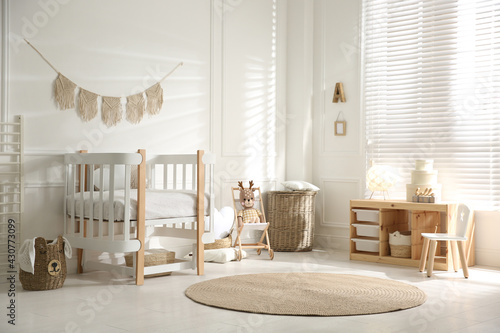 Baby room interior with stylish furniture and toys photo