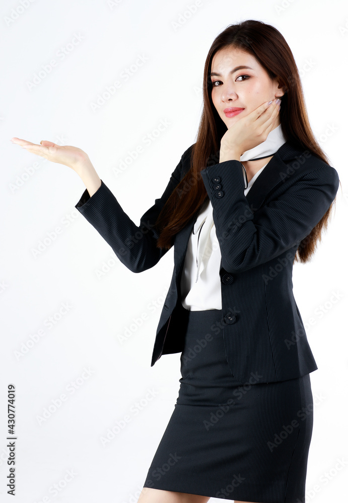 Portrait of young Asian businesswoman in formal suit posing and show hand in blank space for present or demonstrate goods or product in advertising gesture, studio shot on white background Portrait of young Asian businesswoman in formal suit posing and show hand in blank space for present or demonstrate goods or product in advertising gesture, studio shot on white background