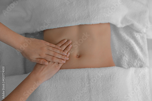 Woman receiving professional belly massage, closeup view