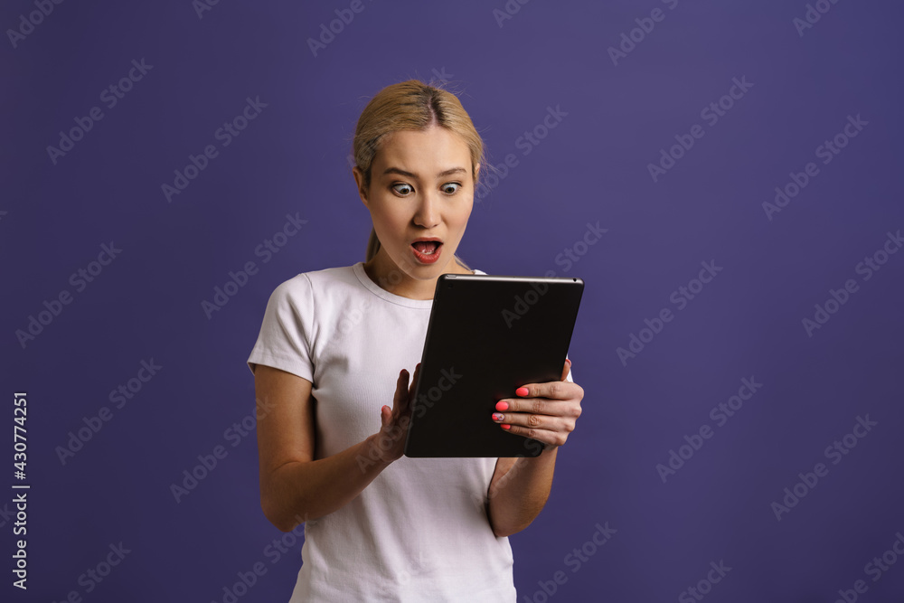 Smiling young asian woman using tablet computer