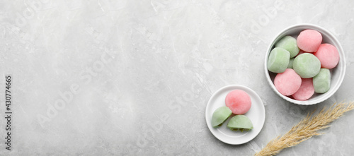 Delicious mochi and pampas grass on light grey marble table, flat lay with space for text. Traditional Japanese dessert