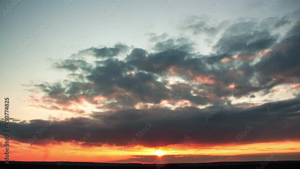 Dramatic intense sunset with many dark clouds. Fast onset of darkness Dramatic intense sunset with many dark clouds. Fast onset of darkness