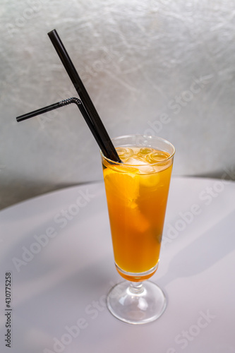 orange cocktail with a slice of orange in a glass glass