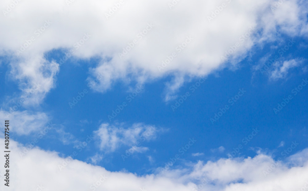 Fototapeta premium Blue sky background and white clouds soft focus, and copy space horizontal shape