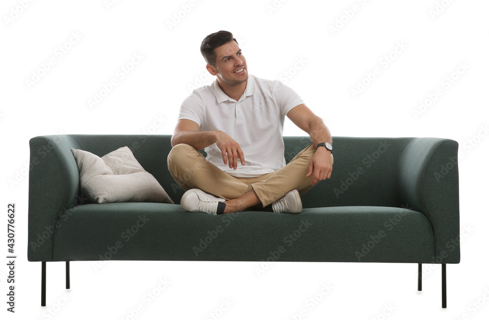 Man relaxing on comfortable green sofa against white background Man relaxing on comfortable green sofa against white background