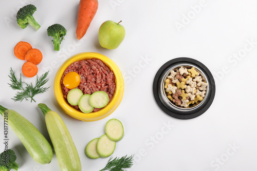 Pet food and natural ingredients on white background, top view