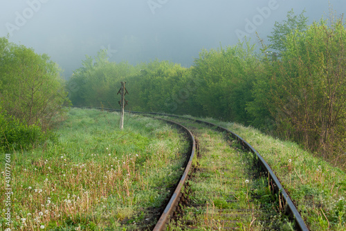 railroad tracks in fog in spring photo