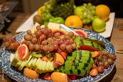 A plate of fruits and vegetables for breakfast on a table  photo