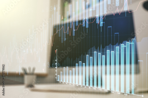 Multi exposure of abstract creative financial chart and modern desktop with laptop on background  research and analytics concept