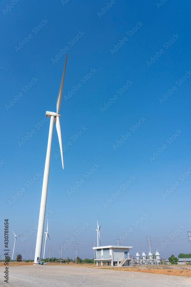 Wind turbines and solar panels in a big green field Wind turbines and solar panels in a big green field