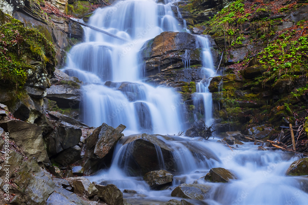 closeup big blue waterfall in mountain canyon closeup big blue waterfall in mountain canyon