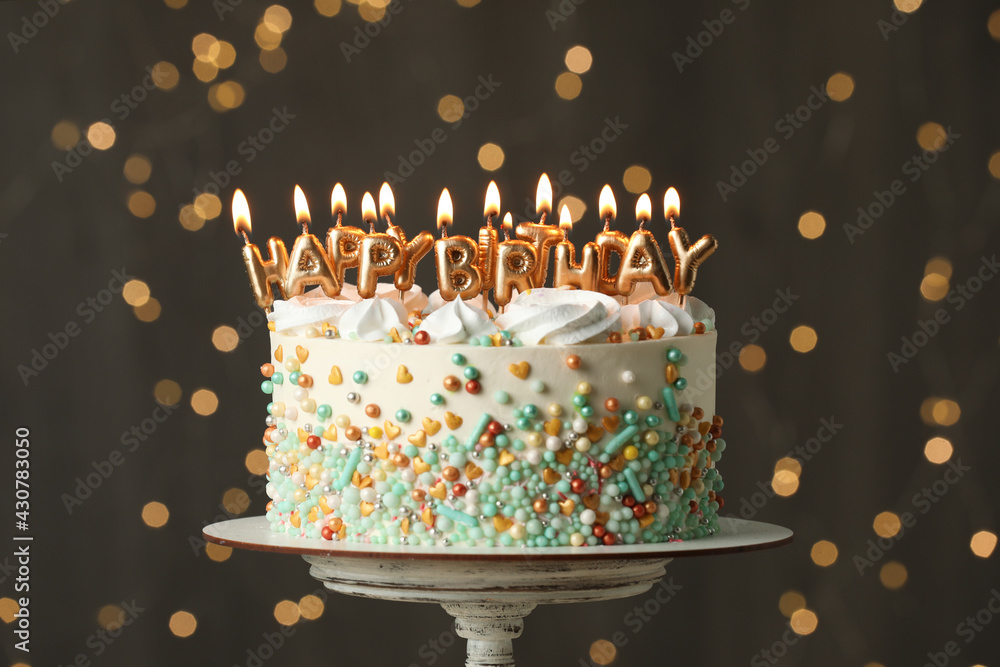 Ταπετσαρία Beautiful birthday cake with burning candles on stand against festive lights