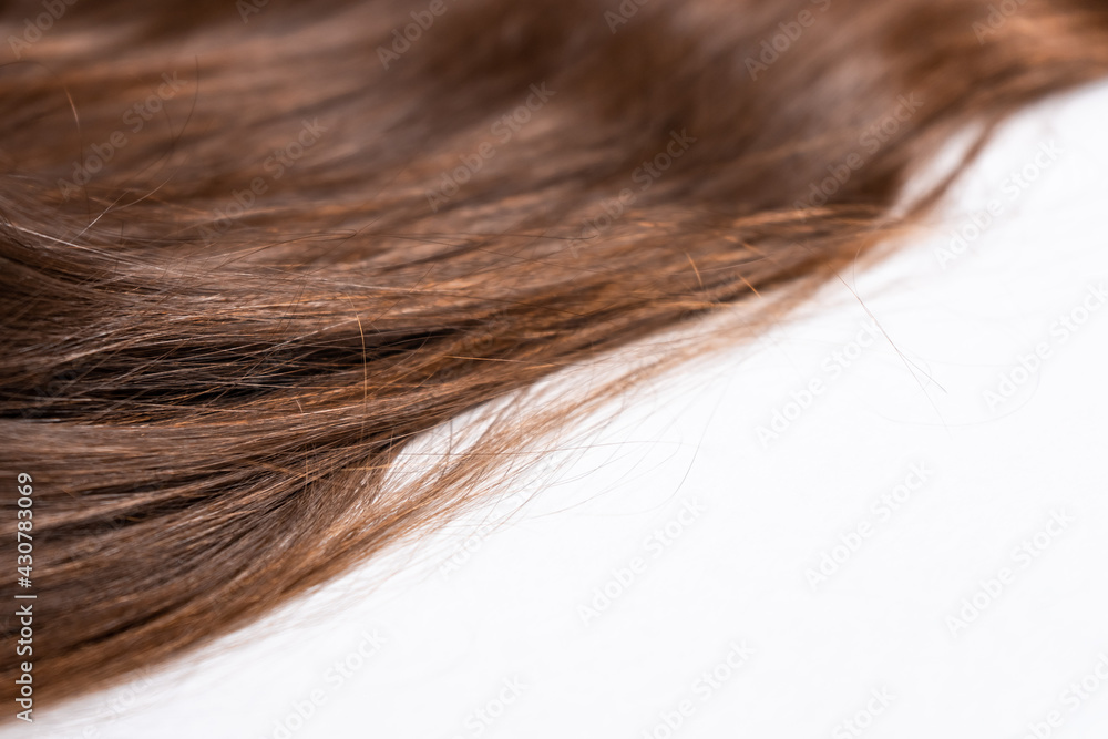 Fototapeta premium Bright brown hair on a white background close-up