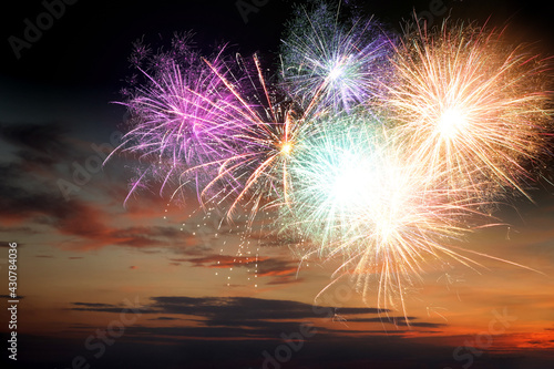 Beautiful bright fireworks lighting up twilight sky outdoors