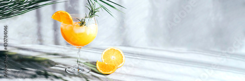 Fotografija Banner with summer soft drink under palm leaf on gray concrete background