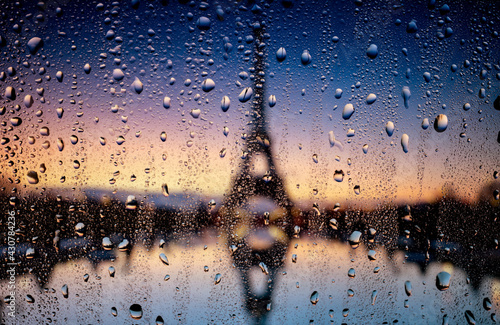 Rain raindrops on the window glass evening city lights macro photo. Bokeh backround.