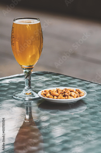 Snacks on table at the street bar, penutsn spring rolls and beer.