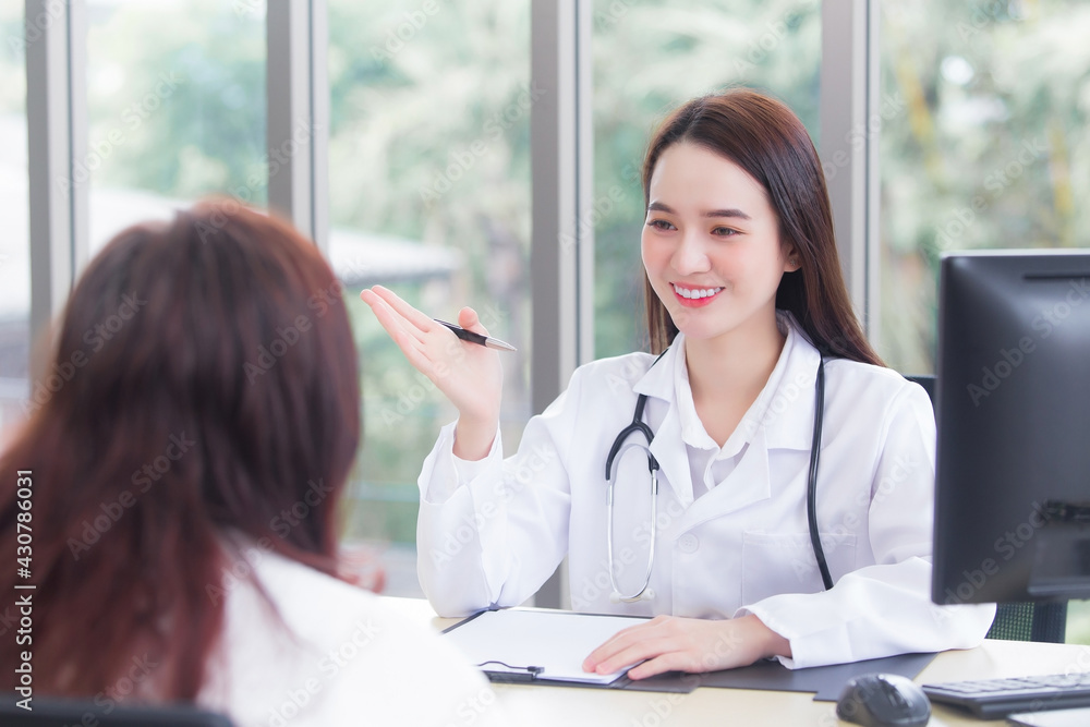 Asian professional woman doctor give suggestion of healthcare information to her patient in examination room at hospital. Asian professional woman doctor give suggestion of healthcare information to her patient in examination room at hospital.