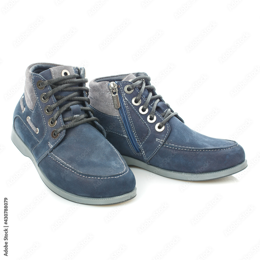 Men's blue leather boots isolated on a blue background. Men's blue leather boots isolated on a blue background.