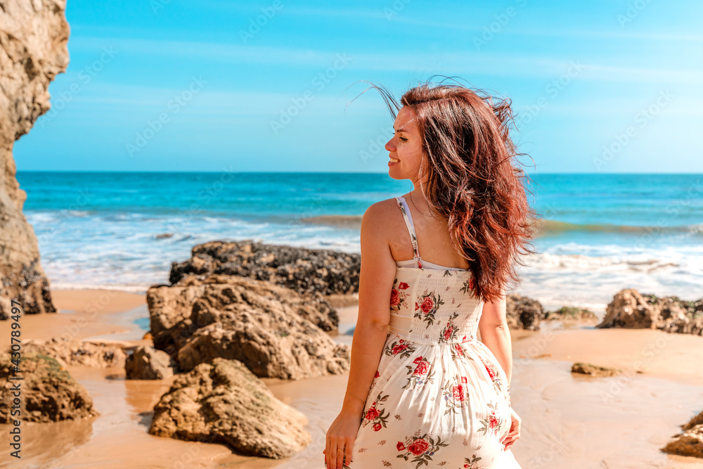 Beautiful woman in dress on Matador Beach near Los Angeles, beautiful rocks and ocean Beautiful woman in dress on Matador Beach near Los Angeles, beautiful rocks and ocean