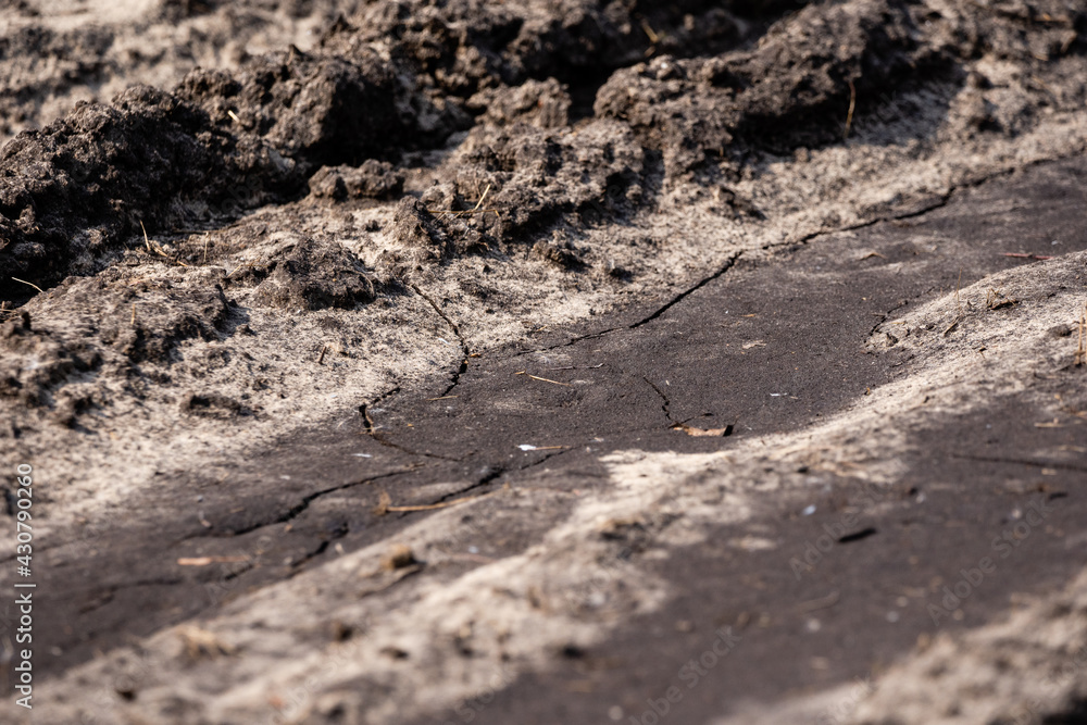 the muddy road is dry in the sun and plays an interesting pattern and imprints the muddy road is dry in the sun and plays an interesting pattern and imprints