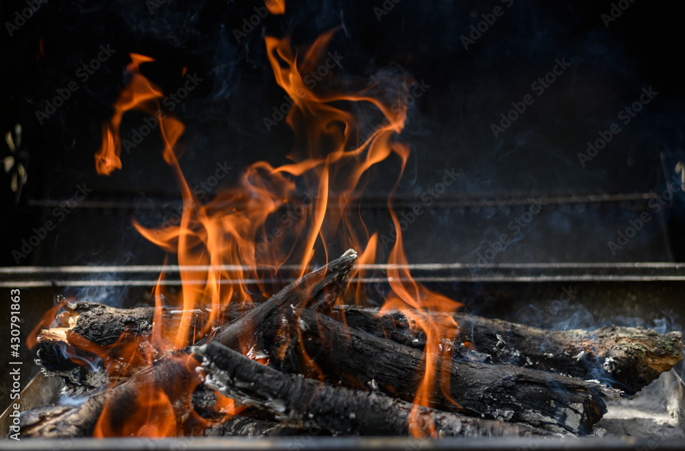 Fototapeta premium A hot fire in barbeque on a black background. Summer bbq concept