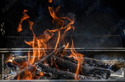 A hot fire in barbeque on a black background. Summer bbq concept