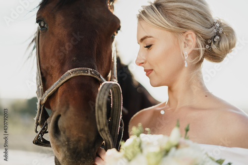 Portrait of a beautiful bride with horse