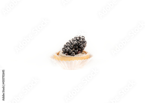 Mini tart with berries isolated, delicious tiny cakes on white background,  small blackberry cake, sweet mini pies, gourmet dessert close-up