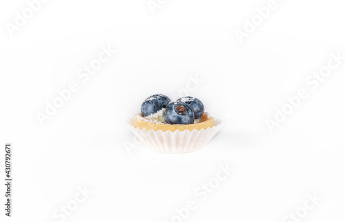 Mini tart with berries isolated, delicious tiny cakes on white background,  small blueberry cakes, sweet mini pies, gourmet dessert close-up 