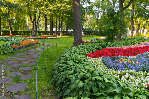 St. Petersburg in summer. A beautiful city park on Elagin Island with walking paths between colorful flower beds. Rest from bustle of city. Comfortable urban environment. Landscaping and horticulture © Katvic