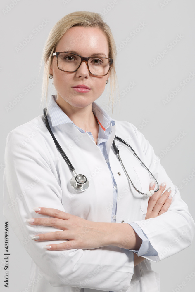 Portrait of a female family doctor in doctor's overall with stethoscope Portrait of a female family doctor in doctor's overall with stethoscope