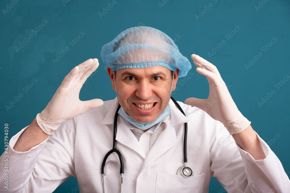 a distraught doctor in a cap and a stethoscope on his shoulders a distraught doctor in a cap and a stethoscope on his shoulders