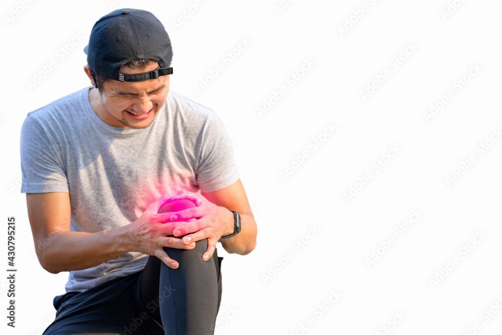 White background: A young Asian male runner holding his knees with his hands. Sitting on a park street from an exercise knee injury: exercise injury concept White background: A young Asian male runner holding his knees with his hands. Sitting on a park street from an exercise knee injury: exercise injury concept