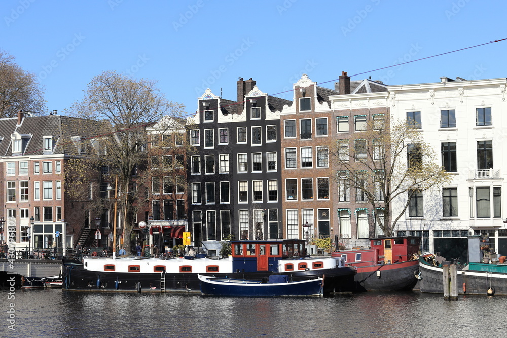 Amsterdam Amstel River View with Historic House Facades and Boats